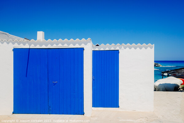 Fisherman's hut with white walls and colorful blue wooden doors  Picture Board by Joaquin Corbalan