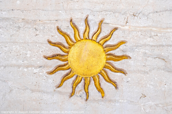 The drawing of a sun with golden rays engraved on marble on a wa Picture Board by Joaquin Corbalan