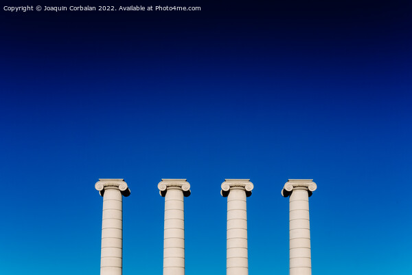 Four classical ionic columns, isolated on blue sky background Picture Board by Joaquin Corbalan