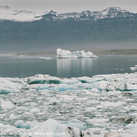 Buy canvas prints of Huge blocks of ice on Glacial river and blue icebergs on Jokulsarlon glacier lake. Vatnajokull National Park, Iceland. by Joaquin Corbalan