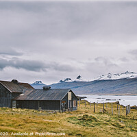 Buy canvas prints of Village with farms in a rural area of the mountains of Iceland, with snowy mountains in the background. by Joaquin Corbalan