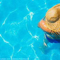 Buy canvas prints of Woman in a pool with hat relaxed and rested. by Joaquin Corbalan
