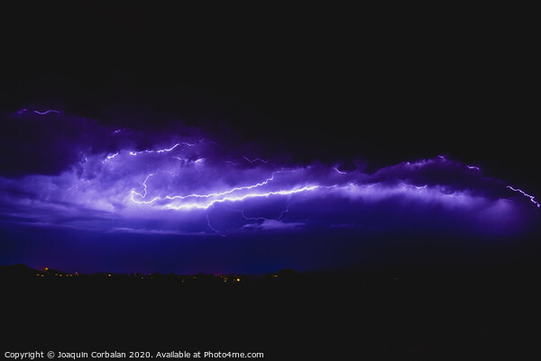 Rays in a night storm with light and clouds. Picture Board by Joaquin Corbalan