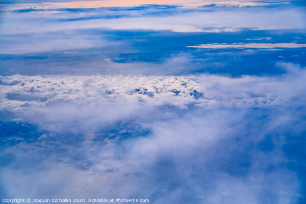 Sea of blue and white clouds seen from above. Picture Board by Joaquin Corbalan