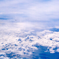 Buy canvas prints of Plane of commercial flights crossing a sky of blue and white clouds seen from above, on the Mediterranean. by Joaquin Corbalan