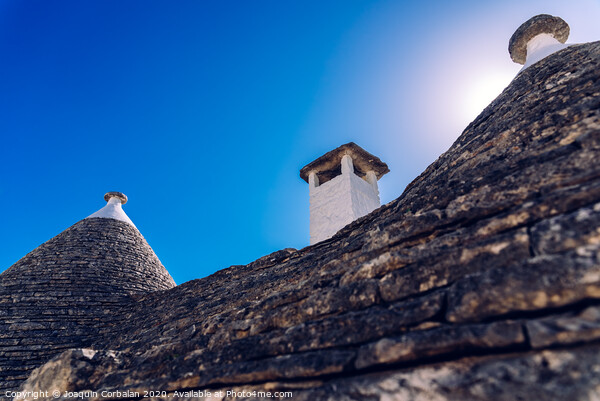 Stone tiles cover the roofs of the trulli in Alberobello, an Italian city to visit on a trip to Italy. Picture Board by Joaquin Corbalan