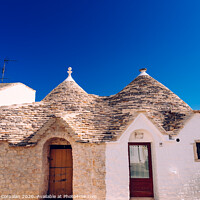 Buy canvas prints of Houses of the tourist and famous Italian city of Alberobello, with its typical white walls and trulli conical roofs. by Joaquin Corbalan