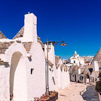 Buy canvas prints of Narrow streets between the trulli of Alberobello, in southern Italy, ideal for family trips. by Joaquin Corbalan