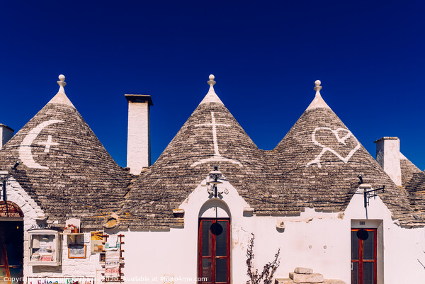 Roofs with symbols in the trulli, in the famous Italian city of Alberobello. Picture Board by Joaquin Corbalan