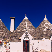 Buy canvas prints of Roofs with symbols in the trulli, in the famous Italian city of Alberobello. by Joaquin Corbalan