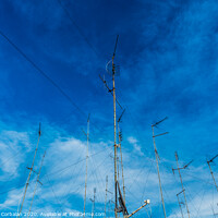 Buy canvas prints of Television antennas on the roof of an old building with dramatic sky. by Joaquin Corbalan