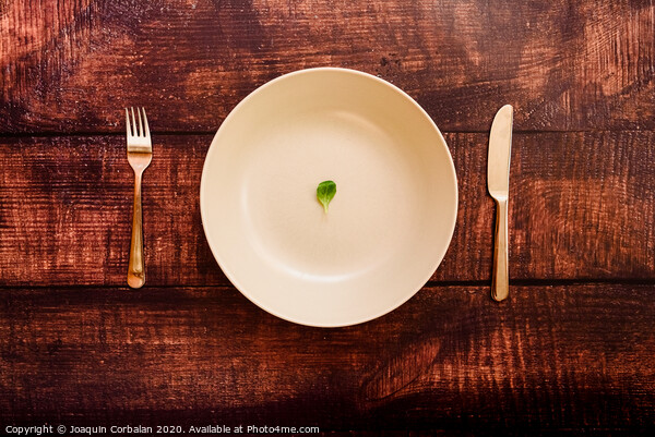Diet to lose weight, image of plate and cutlery with a little scanty vegetable. Picture Board by Joaquin Corbalan