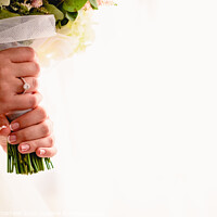 Buy canvas prints of A woman's hand with wedding ring while holding her bouquet, plenty of white copy space. by Joaquin Corbalan