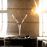 Buy canvas prints of Empty glass cup with sun flares background in a restaurant. by Joaquin Corbalan
