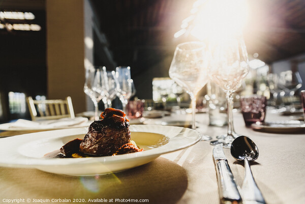 Exquisite veal dish with sauce served in luxury cutlery with sunbeams in a restaurant. Picture Board by Joaquin Corbalan