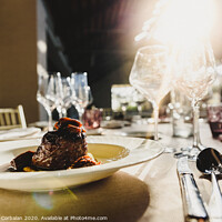 Buy canvas prints of Exquisite veal dish with sauce served in luxury cutlery with sunbeams in a restaurant. by Joaquin Corbalan