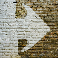 Buy canvas prints of Brick wall with big white arrow indicating direction, background with copy space. by Joaquin Corbalan