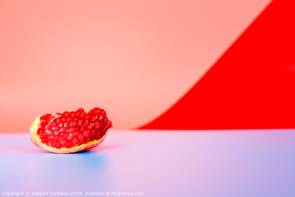 Autumn is the time of pomegranates, open fruit isolated on plain colored backgrounds. Picture Board by Joaquin Corbalan