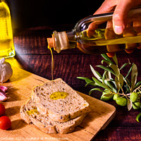 Buy canvas prints of A Mediterranean cook prepares a slice of bread with virgin olive oil, tomatoes and garlic, a traditional breakfast in the Mediterranean countries. by Joaquin Corbalan