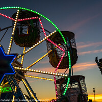 Buy canvas prints of Amusement park at dusk with ferris wheel in the background. by Joaquin Corbalan