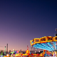 Buy canvas prints of Amusement park at dusk with ferris wheel in the background. by Joaquin Corbalan