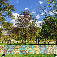 Buy canvas prints of Wooden bench to rest decorated with a beautiful design of labyrinthine lines in a public garden. by Joaquin Corbalan
