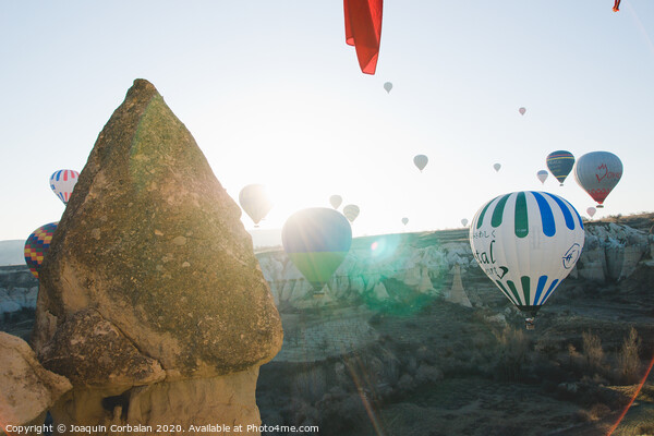 Colorful balloons flying over mountains and with blue sky in cappadocia. Picture Board by Joaquin Corbalan