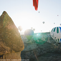 Buy canvas prints of Colorful balloons flying over mountains and with blue sky in cappadocia. by Joaquin Corbalan