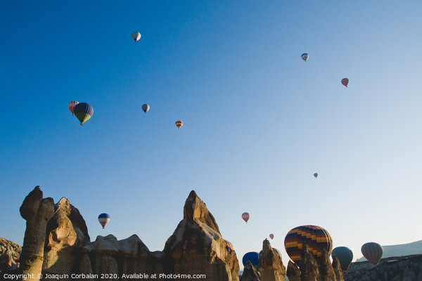 Colorful balloons flying over mountains and with blue sky Picture Board by Joaquin Corbalan