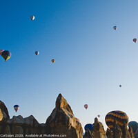 Buy canvas prints of Colorful balloons flying over mountains and with blue sky by Joaquin Corbalan