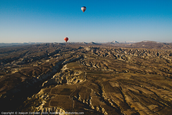 Colorful balloons flying over mountains and with blue sky in cappadocia Picture Board by Joaquin Corbalan