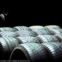 Buy canvas prints of Old tires and racing wheels stacked in the sun by Joaquin Corbalan
