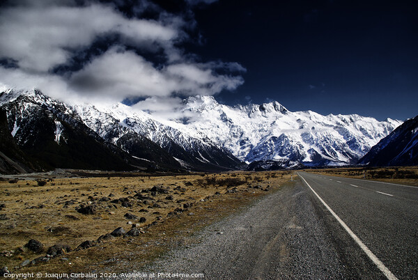 Snowy mountains among clouds from road Picture Board by Joaquin Corbalan