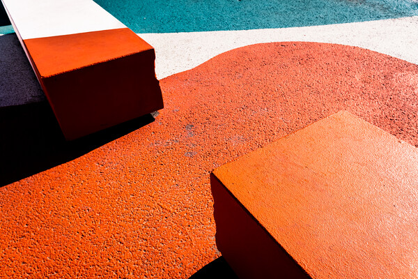 Asphalt floor painted in orange, with concrete blocks of harsh shadows of sunlight, abstract background. Picture Board by Joaquin Corbalan