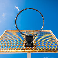 Buy canvas prints of An old basketball basket outside a street with blue sky, copy space for text. by Joaquin Corbalan