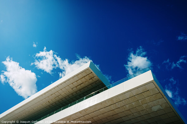 Blue sky background with clouds and a roof of modern financial business building. Picture Board by Joaquin Corbalan