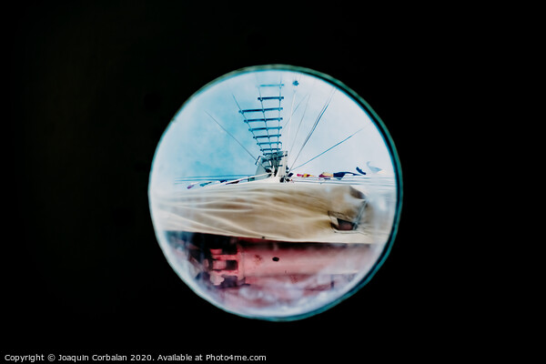 Ship moored to port seen through from inside the porthole of a ship. Picture Board by Joaquin Corbalan