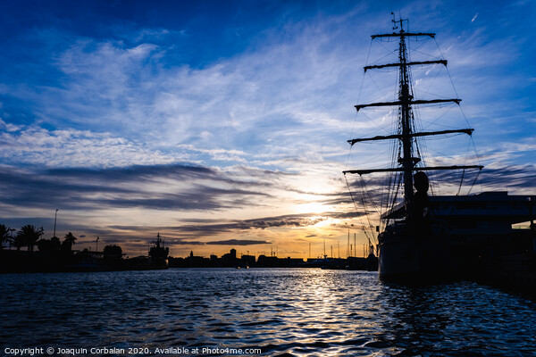 A classic sailboat moored to port in a beautiful sunset. Picture Board by Joaquin Corbalan