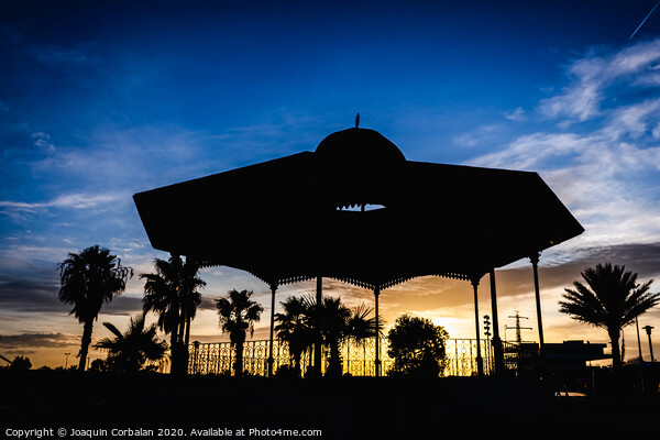 Silhouette of a pergola at sunset on a cloudy afternoon in the port of the Marina Real of Valencia, Spain. Picture Board by Joaquin Corbalan