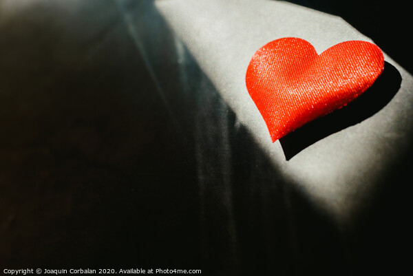 Red hearts isolated dark background illuminated by a ray of sun to use in the background, with a lot of empty space copy space. Picture Board by Joaquin Corbalan