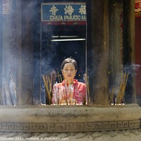 Buy canvas prints of Ho Chi Ming, Vietnam - 27 October 2011: Asian religious people praying in Vietnam temple by Joaquin Corbalan