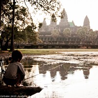 Buy canvas prints of Girl fishing in the lake of Angkor Wat, ancient Cambodian city hidden in the forest very visited by tourists by Joaquin Corbalan