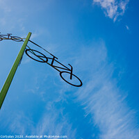Buy canvas prints of Post with the figure of some bicycles indicating the road, with blue sky and clouds in the background. by Joaquin Corbalan