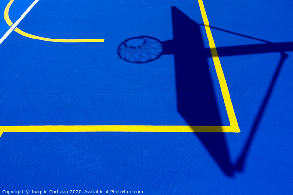 Shadow of a basketball basket on the floor of the court, painted blue and background with lines. Picture Board by Joaquin Corbalan