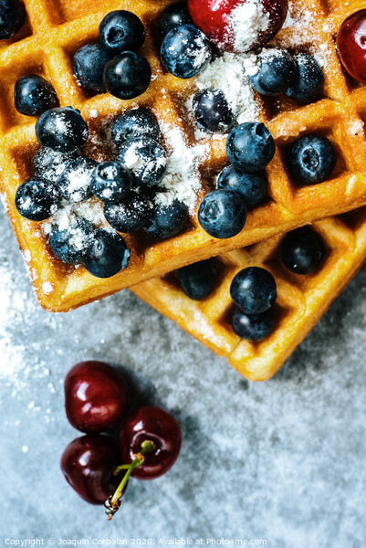 Close-up of waffles with tasty fruits cranberries, cherries and strawberries viewed from above, isolated on abstract background with copy space for text. Picture Board by Joaquin Corbalan