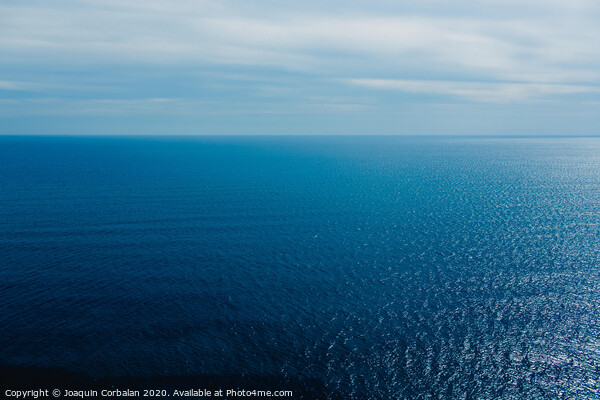 Calm blue sea without waves seen from a cliff with room for text Picture Board by Joaquin Corbalan