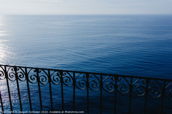 Calm blue sea without waves seen from a cliff with room for text Picture Board by Joaquin Corbalan