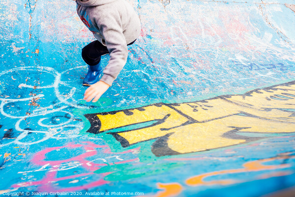 Boy running inside an urban skatepark with sweatshirt having fun, blue tones. Picture Board by Joaquin Corbalan