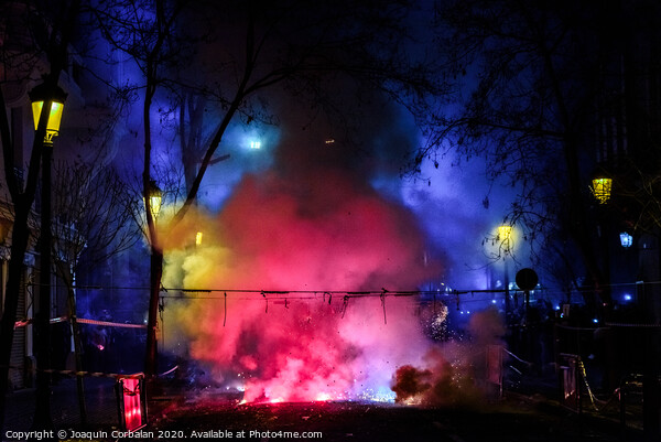 Colorful mascleta full of firecrackers and fireworks with lots of smoke and sparks. Picture Board by Joaquin Corbalan