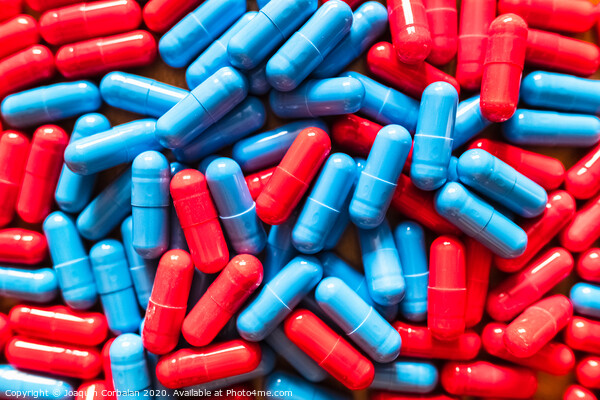 Choosing between two options is difficult, many red and blue pills mixed to choose which one to take. Picture Board by Joaquin Corbalan